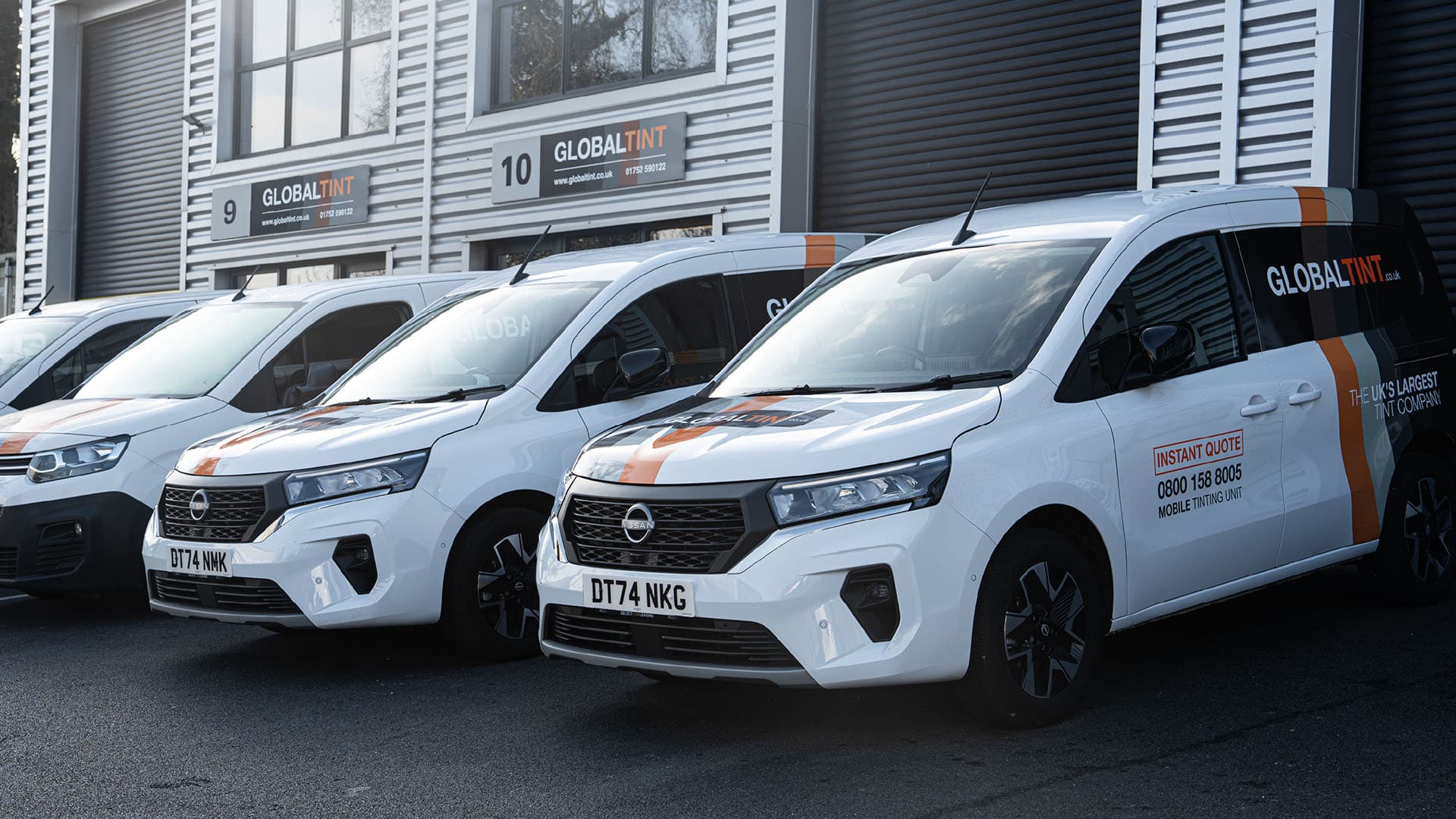 Global Tint fleet of branded vans at headquarters